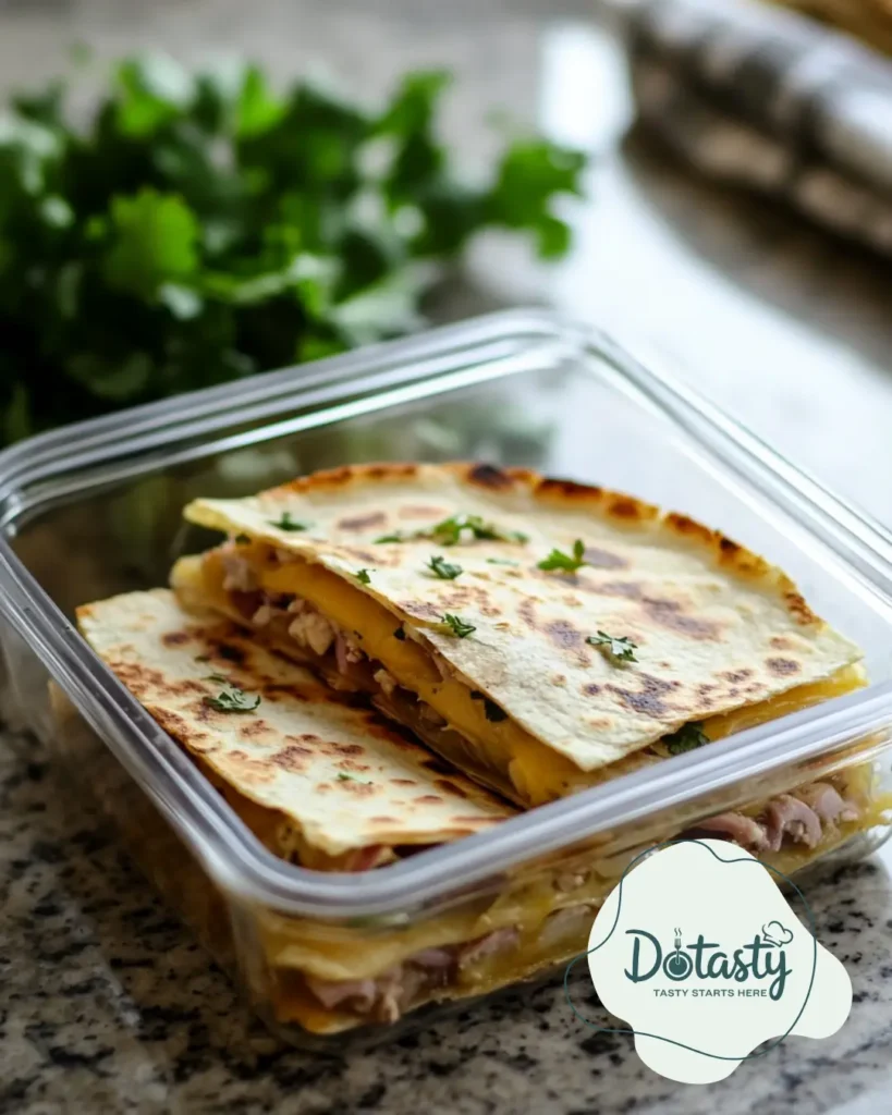 Leftover Reuben Quesadilla slices neatly stored in an airtight container.