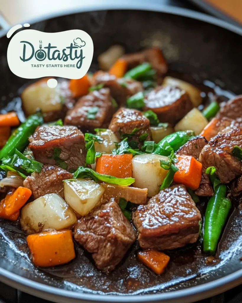 Steak and vegetables added to a hot pan with soy sauce.