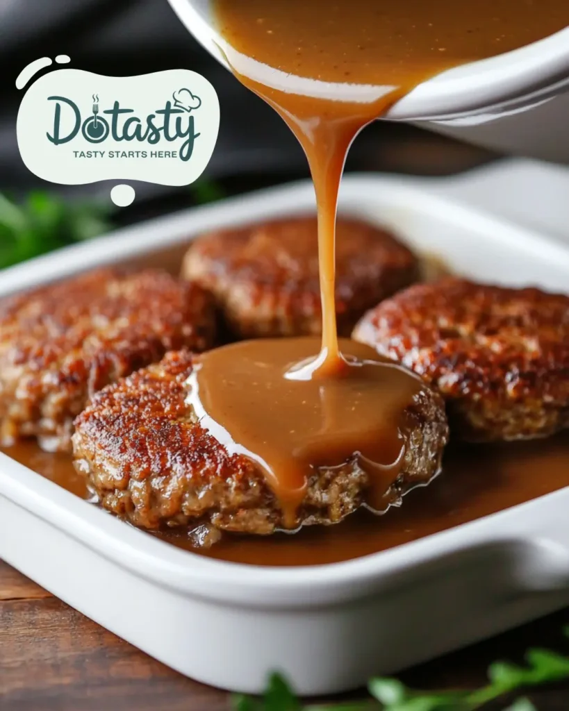Hamburger patties and gravy mixture being added to casserole