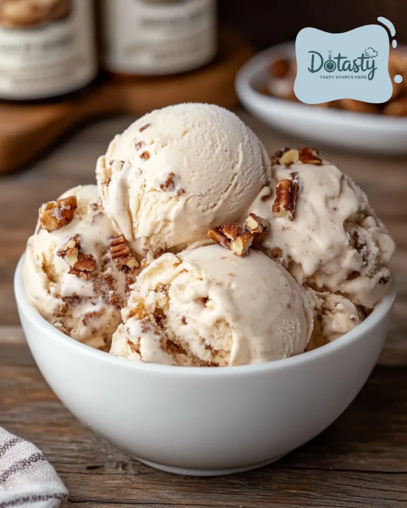 Homemade brown butter ice cream scooped in a bowl on a wood table