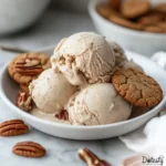 Homemade brown butter ice cream scooped in a bowl on a wood table