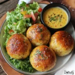 Buttery cheeseburger bombs topped with garlic parmesan, served hot.